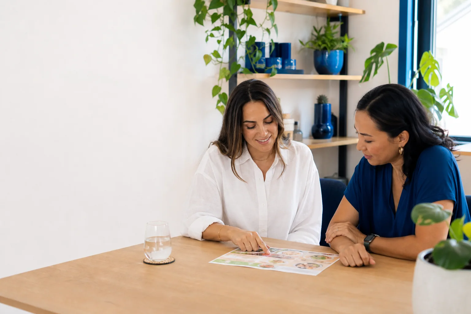 Two people reviewing a colorful nutrition plan together