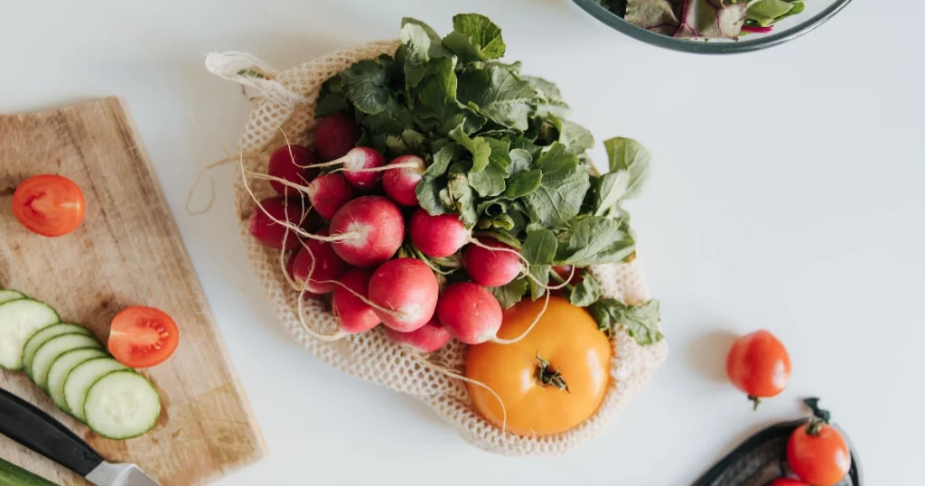 A beautiful arrangement of fresh, low FODMAP vegetables and ingredients representing the 3 phases of the low FODMAP diet.
